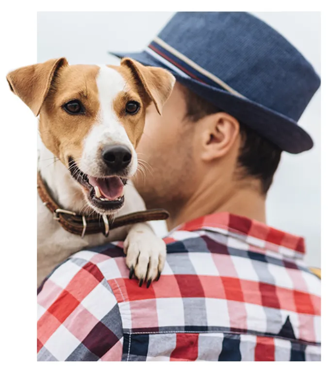 Man in hat with happy dog